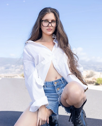 White Shirt And Denim Style With Esfinge On A Mountain Road